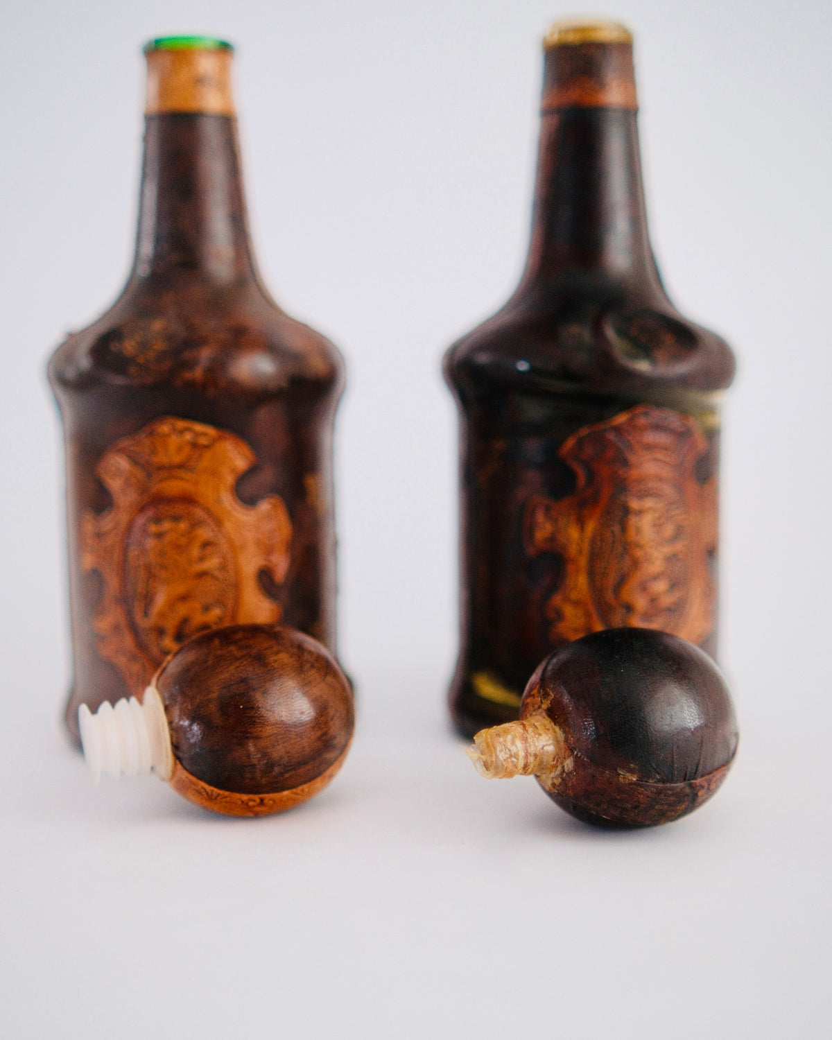 The Medici Pair | Mid-Century Italian Leather-Wrapped Decanters with Embossed Lion Crests